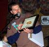 Eric about to award a door prize, a WW-signed, framed humbucker. WW's autograph reads, ''The buck stops here!'' (pic 27).
